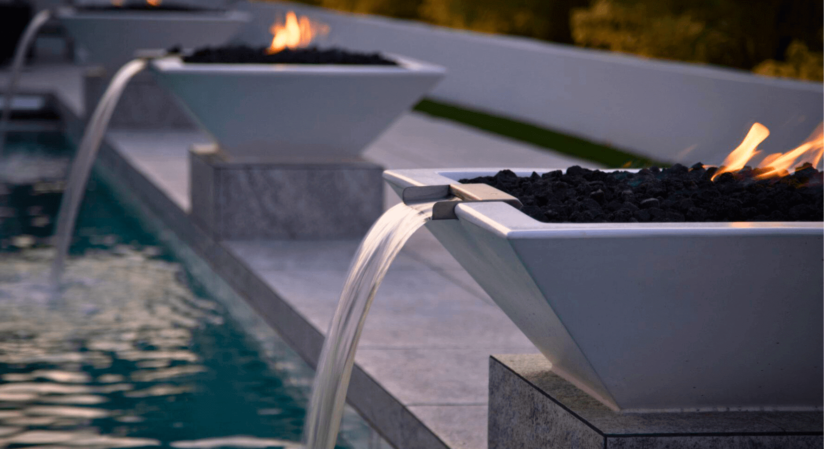 fire and water bowls by the outdoor plus next to a pool