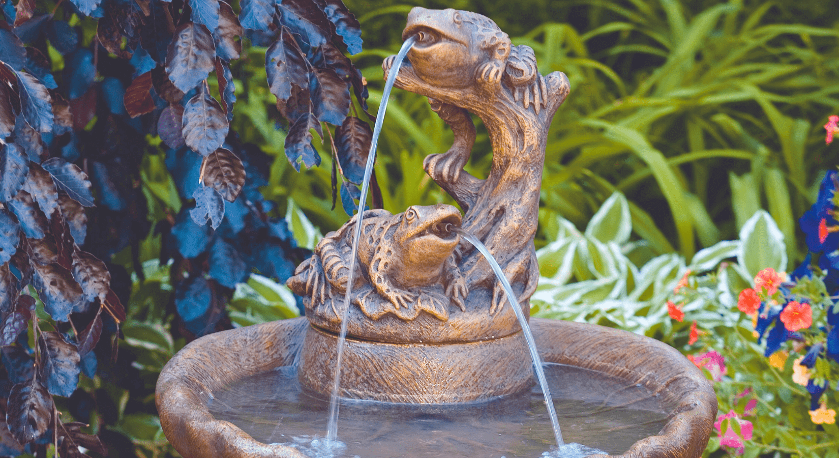 massarelli frogs spitter style water fountain in a garden