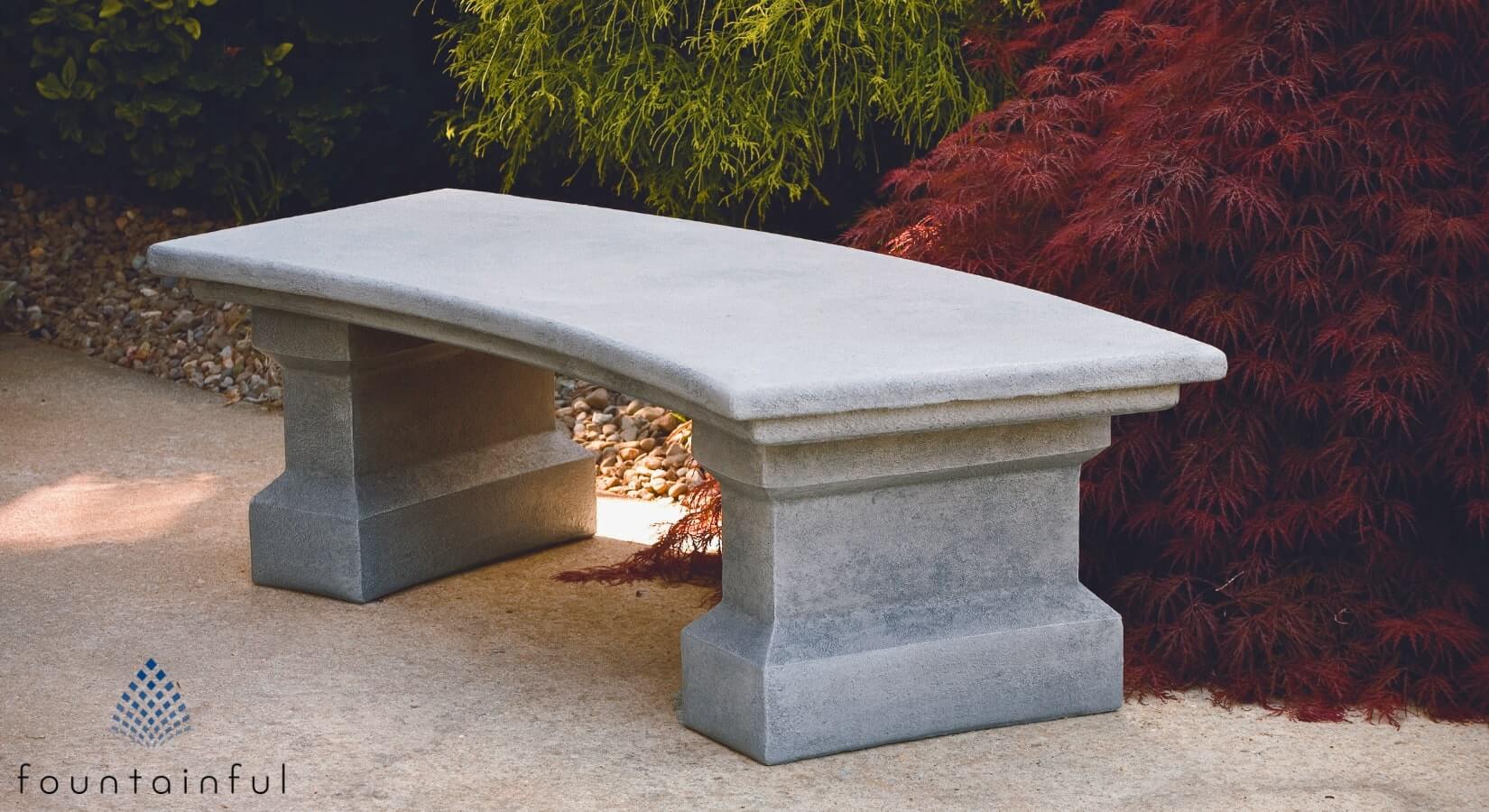 massarelli's classic curved concrete garden bench on a pathway