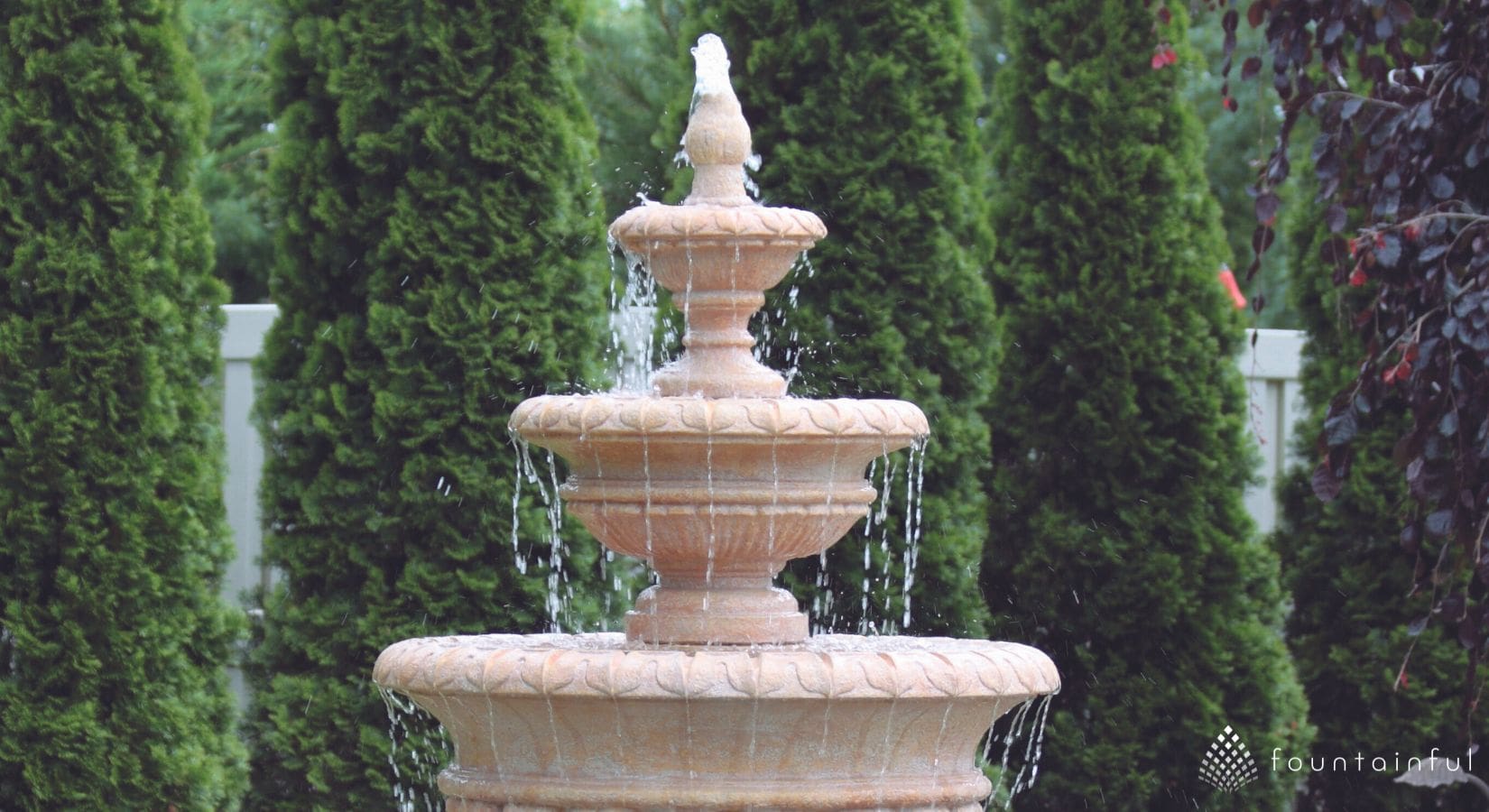 a loud scupper style massarelli water fountain in a garden